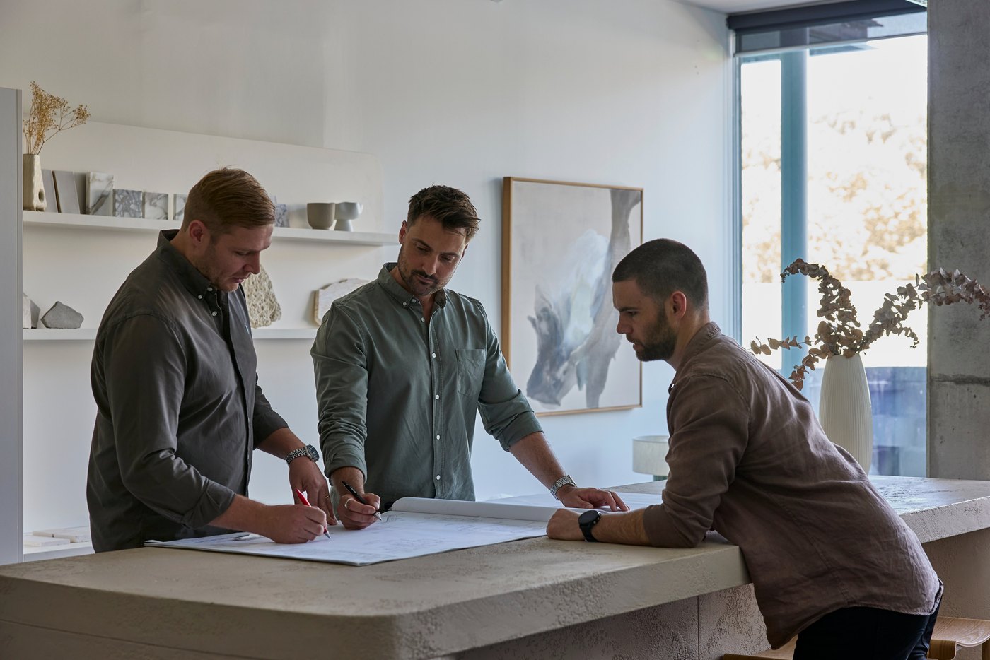 Stratton Thomas and the Nuebelle team reviewing drawings in the studio